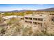 Sweeping aerial shot of community with desert landscaping and picturesque mountain views at 36601 N Mule Train Rd # D30, Carefree, AZ 85377