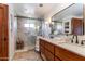 Contemporary bathroom with glass shower, double sinks, and wooden accents for a sophisticated look at 36601 N Mule Train Rd # D30, Carefree, AZ 85377