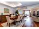 Dining area with hardwood floors and a tray ceiling flows to an open concept living room with fireplace at 36601 N Mule Train Rd # D30, Carefree, AZ 85377