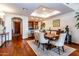 Dining area with wood floors adjacent to the kitchen with bar seating and access to living area at 36601 N Mule Train Rd # D30, Carefree, AZ 85377