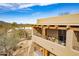 Exterior view showcasing the beautiful architecture and private balconies with desert landscaping at 36601 N Mule Train Rd # D30, Carefree, AZ 85377