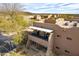 View of modern, multi-level condo buildings with covered balconies and desert landscaping at 36601 N Mule Train Rd # D30, Carefree, AZ 85377