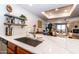 Bright kitchen featuring a marble countertop and stainless steel sink that opens to the living area at 36601 N Mule Train Rd # D30, Carefree, AZ 85377