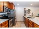 Kitchen featuring wood cabinets, stainless steel appliances, and light countertops at 36601 N Mule Train Rd # D30, Carefree, AZ 85377