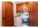 Well-lit laundry area featuring a new washer, dryer and classic wooden cabinets at 36601 N Mule Train Rd # D30, Carefree, AZ 85377