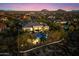 Twilight aerial view of a private residence with a pool, spa, and mountain views at 37080 N 109Th Way, Scottsdale, AZ 85262