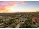 Panoramic aerial view of a luxury home at sunset with desert surroundings and mountain views at 37080 N 109Th Way, Scottsdale, AZ 85262