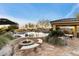 Backyard with a pool, built-in fire pit, BBQ, and covered patio, perfect for outdoor entertaining at 37080 N 109Th Way, Scottsdale, AZ 85262