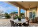 Back patio featuring an outdoor dining area and lounge area with a clear view of the lush backyard at 37080 N 109Th Way, Scottsdale, AZ 85262