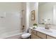 Cozy bathroom features a large vanity, tub with shower, tile backsplash, and bright natural light at 37080 N 109Th Way, Scottsdale, AZ 85262