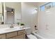 Cozy bathroom features a large vanity, tub with shower, tile backsplash, and bright natural light at 37080 N 109Th Way, Scottsdale, AZ 85262