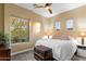 Cozy bedroom with a ceiling fan, natural light, and neutral decor at 37080 N 109Th Way, Scottsdale, AZ 85262