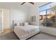 Bright bedroom featuring a queen bed, neutral carpet, and a large window with backyard view at 37080 N 109Th Way, Scottsdale, AZ 85262