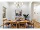 Elegant dining room featuring a decorative chandelier, wall art, and a plant for added color at 37080 N 109Th Way, Scottsdale, AZ 85262