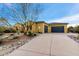 Stunning exterior showcasing a well-maintained lawn, desert landscaping, and a spacious two-car garage at 37080 N 109Th Way, Scottsdale, AZ 85262