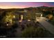 Beautiful home exterior with desert landscaping and a long driveway at sunset at 37080 N 109Th Way, Scottsdale, AZ 85262