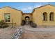 Charming front entrance with a decorative gate, desert landscaping, and unique architectural details at 37080 N 109Th Way, Scottsdale, AZ 85262