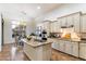 Kitchen featuring granite counters, central island, and dining area in an open-concept design at 37080 N 109Th Way, Scottsdale, AZ 85262