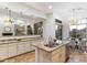 Bright kitchen featuring granite countertops, central island, and an open view to dining and living rooms at 37080 N 109Th Way, Scottsdale, AZ 85262