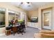 Living room with a workspace, leather seating, and a ceiling fan at 37080 N 109Th Way, Scottsdale, AZ 85262