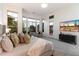 Bright main bedroom with large windows and a glass door leading to an outdoor space at 37080 N 109Th Way, Scottsdale, AZ 85262