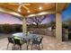 Covered patio with a built-in outdoor kitchen with grill and dining space at 37080 N 109Th Way, Scottsdale, AZ 85262