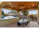 Covered patio offers views of the pool and natural desert landscape, providing a serene outdoor living space at 37080 N 109Th Way, Scottsdale, AZ 85262