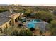 Aerial view of the backyard with a pool, spa, swim up bar, and fire pit at 37080 N 109Th Way, Scottsdale, AZ 85262