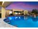 Lush backyard features a pool with swim-up bar and beautiful landscaping at 37080 N 109Th Way, Scottsdale, AZ 85262