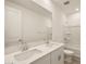 Bathroom featuring double sinks with modern fixtures, a large mirror, and a combined tub and shower at 37093 W La Paz St, Maricopa, AZ 85138