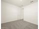 Neutral bedroom with carpet, a white door, and a view to the hallway at 37093 W La Paz St, Maricopa, AZ 85138