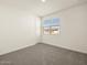 Neutral bedroom with carpet, a window with blinds, and a closet door at 37093 W La Paz St, Maricopa, AZ 85138