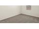 Neutral bedroom with carpet, baseboards, and a window at 37093 W La Paz St, Maricopa, AZ 85138