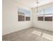 Well-lit dining room with elegant chandelier and ample space for entertaining guests or Gathering at 37093 W La Paz St, Maricopa, AZ 85138