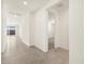 Bright hallway with tile flooring, leading to an open living space and a view of the outdoor patio at 37093 W La Paz St, Maricopa, AZ 85138