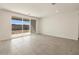 Expansive living area with tile flooring, neutral paint, and a large sliding door to the backyard at 37093 W La Paz St, Maricopa, AZ 85138