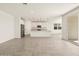 Open-concept living area with tile floors leading to a bright, modern kitchen at 37093 W La Paz St, Maricopa, AZ 85138