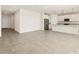 Bright open-concept living room and kitchen featuring tile floors and neutral walls at 37093 W La Paz St, Maricopa, AZ 85138