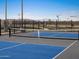 Outdoor pickleball court with blue and gray surface, and mountain views in the distance at 37093 W La Paz St, Maricopa, AZ 85138