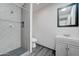 Modern bathroom featuring a shower with gray-tiled walls, and a vanity providing both style and functionality at 3714 E Polk St, Phoenix, AZ 85008