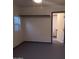 View of simple bedroom with dark painted trim and closet shelving at 3714 E Polk St, Phoenix, AZ 85008