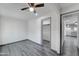 Open-concept bedroom features gray flooring, a ceiling fan, and an open closet space at 3714 E Polk St, Phoenix, AZ 85008