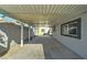 Carport featuring a large open parking area with concrete flooring and gray walls at 3714 E Polk St, Phoenix, AZ 85008