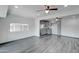 Open-concept living room flows to the kitchen with gray cabinets and wood-look floors at 3714 E Polk St, Phoenix, AZ 85008