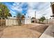 Large backyard with dirt, multiple storage sheds, and a block fence at 398 W Elgin St, Chandler, AZ 85225