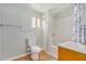 Bathroom features tub, shower, neutral walls, and a window offering plenty of natural light at 398 W Elgin St, Chandler, AZ 85225