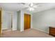 Bedroom view showing closet, neutral walls, ceiling fan, carpet, and natural lighting at 398 W Elgin St, Chandler, AZ 85225