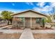 Front exterior view of the home featuring a sidewalk, desert landscaping, and secure fencing at 398 W Elgin St, Chandler, AZ 85225