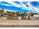 Exterior view of the home, showcasing its landscaping, trees, and fencing at 398 W Elgin St, Chandler, AZ 85225