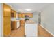 Bright kitchen featuring wood cabinetry, updated appliances, and a kitchen island in an open layout at 398 W Elgin St, Chandler, AZ 85225